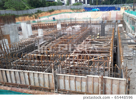 KUALA LUMPUR, MALAYSIA -JULY 14, 2017: Construction workers fabricating steel reinforcement bar at the construction site. The reinforcement bar was tie together using tiny wires.   65448596