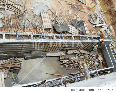 KUALA LUMPUR, MALAYSIA -JULY 14, 2017: Construction workers fabricating steel reinforcement bar at the construction site. The reinforcement bar was tie together using tiny wires.   65448607