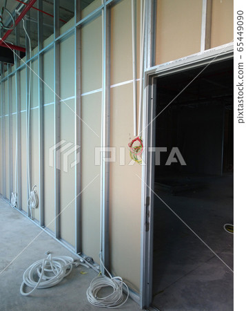 KUALA LUMPUR, MALAYSIA -APRIL 12, 2018: Drywall installation work in progress by construction workers at the construction site. It is the easiest and cheapest way to do partition for an interior wall. 65449090