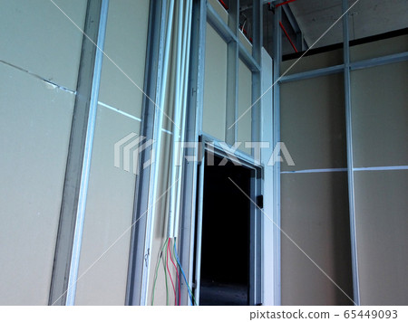 KUALA LUMPUR, MALAYSIA -APRIL 12, 2018: Drywall installation work in progress by construction workers at the construction site. It is the easiest and cheapest way to do partition for an interior wall. 65449093