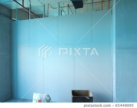 KUALA LUMPUR, MALAYSIA -APRIL 12, 2018: Drywall installation work in progress by construction workers at the construction site. It is the easiest and cheapest way to do partition for an interior wall. 65449095