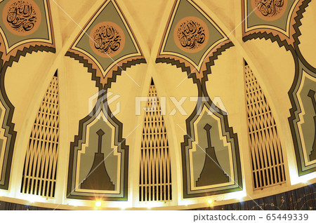 SARAWAK, MALAYSIA -OCTOBER 14, 2014: The interior of Sarawak State Mosque. The mosque has one big main prayer hall covered with one big and beautiful dome and supported with other small domes.  65449339