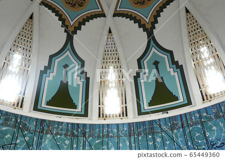 SARAWAK, MALAYSIA -OCTOBER 14, 2014: The interior of Sarawak State Mosque. The mosque has one big main prayer hall covered with one big and beautiful dome and supported with other small domes. SARAWAK, MALAYSIA -OCTOBER 14, 2014: The interior of Sarawak State Mosque. The mosque has one big main prayer hall covered with one big and beautiful dome and supported with other small domes. 65449360
