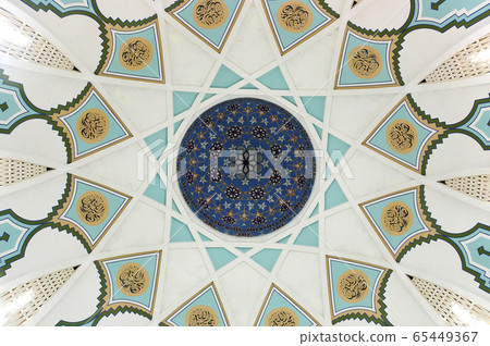 SARAWAK, MALAYSIA -OCTOBER 14, 2014: The interior of Sarawak State Mosque. The mosque has one big main prayer hall covered with one big and beautiful dome and supported with other small domes. SARAWAK, MALAYSIA -OCTOBER 14, 2014: The interior of Sarawak State Mosque. The mosque has one big main prayer hall covered with one big and beautiful dome and supported with other small domes. 65449367