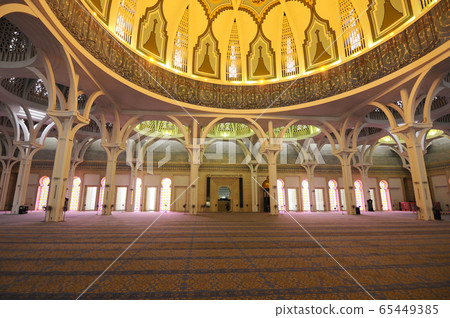 SARAWAK, MALAYSIA -OCTOBER 14, 2014: The interior of Sarawak State Mosque. The mosque has one big main prayer hall covered with one big and beautiful dome and supported with other small domes.  65449385