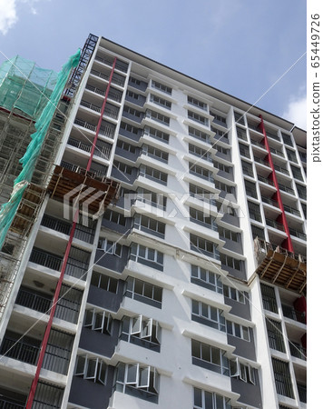 KUALA LUMPUR, MALAYSIA -JULY 20, 2017: Under construction of high rise apartment building with modern facade design. Apartment housing popular in the urban area in Malaysia. 65449726