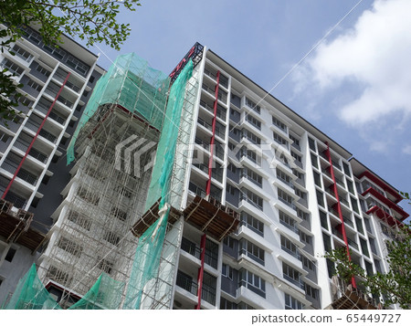 KUALA LUMPUR, MALAYSIA -JULY 20, 2017: Under construction of high rise apartment building with modern facade design. Apartment housing popular in the urban area in Malaysia. 65449727