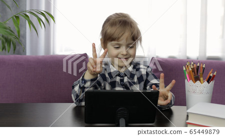 Girl studying online homework using digital tablet computer. Distance education 65449879