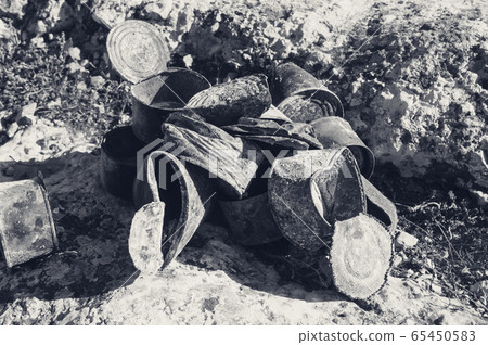 Group of old rusty tin cans covered with ash on Group of old rusty tin cans covered with ash on 65450583