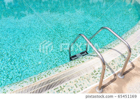 Railings with stainless steel for a pool with clean, clear, blue water. 65451169