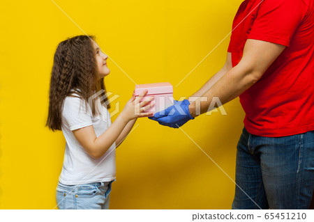 Child girl accepting a delivery of box from Child girl accepting a delivery of box from 65451210