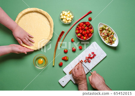 Making a pie top view. Young couple home baking Making a pie top view. Young couple home baking 65452015
