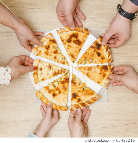 A large group of children and adults hold a piece A large group of children and adults hold a piece 65452219