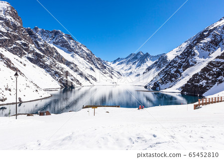 ski in chile on a sunny day with lots of snow. 65452810