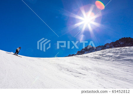 ski in chile on a sunny day with lots of snow. 65452812