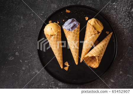 Top view of ice cream cones in a big black plate Top view of ice cream cones in a big black plate 65452907