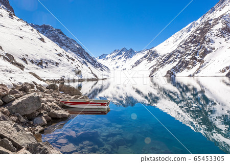 ski in chile on a sunny day with lots of snow. 65453305
