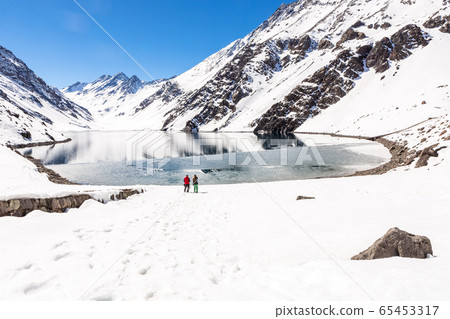 ski in chile on a sunny day with lots of snow. 65453317