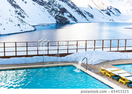 ski in chile on a sunny day with lots of snow. 65453325