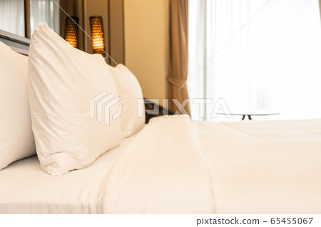 Pillow and blanket on bed with light lamp decoration interior 65455067