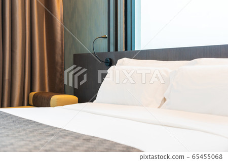 Beautiful luxury comfortable white pillow and blanket on bed with light lamp 65455068