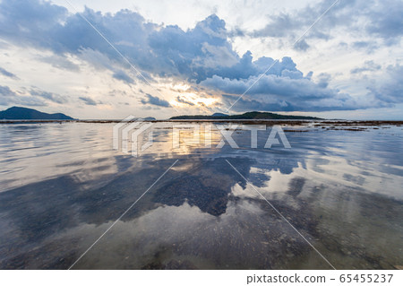 .beautiful cloud at sunrise above the coral reef 65455237