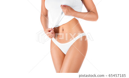 Slim tanned woman's body. Woman showing her waist. Isolated over white background. Slim tanned woman's body. Woman showing her waist. Isolated over white background. 65457185