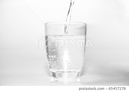 bright water dripping into the glass with many bubble in water bright blue background . healthcare drinking advertising concept bright water dripping into the glass with many bubble in water bright blue background . healthcare drinking advertising concept 65457276
