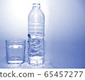 blue fresh water in plastic bottle and full water in glass bright blue background . drinking healthcare concept . 65457277