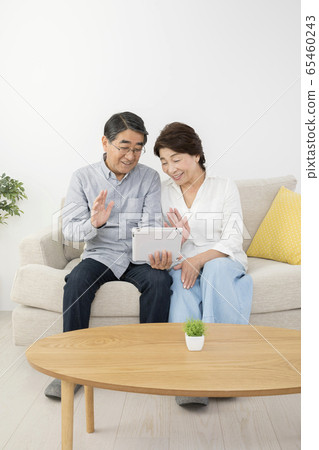 年長的夫婦拒絕出去在平板電腦上進行視頻通話 65460243