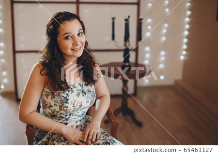 the girl is sitting on the chairs. spending time in self-isolation. interior decoration the girl is sitting on the chairs. spending time in self-isolation. interior decoration 65461127