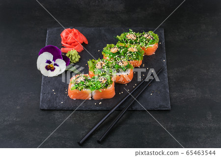 Sushi rolls with seafood and Chuka salad. Green sushi. Top view. Free space for your text. Sushi rolls with seafood and Chuka salad. Green sushi. Top view. Free space for your text. 65463544