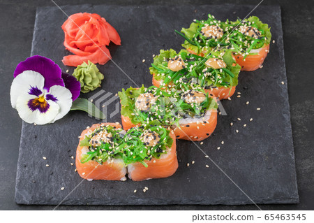 Sushi rolls with seafood and Chuka salad. Green sushi. Top view. Free space for your text. 65463545