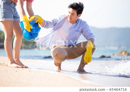Men and women doing beach clean 65464716