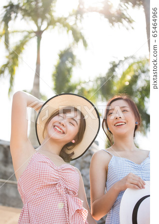 Young women enjoying a resort trip 65464966