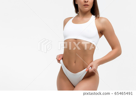 Fit woman in underwear on white background 65465491