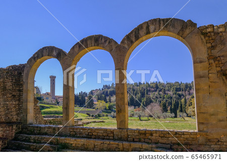 Close up of the preserved roman arches and the tower of the San Romolo Cathedral, Fiesole, Florence, Tuscany, Italy Close up of the preserved roman arches and the tower of the San Romolo Cathedral, Fiesole, Florence, Tuscany, Italy 65465971