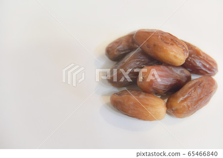 several dry dates on the white background several dry dates on the white background 65466840