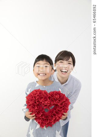 A mother with a child with a heart A mother with a child with a heart 65466892