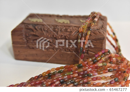 carved wooden box and tourmaline beads. selective carved wooden box and tourmaline beads. selective 65467277