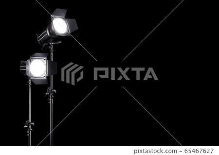Photography studio flash on a lighting stand isolated on black background. Photography studio flash on a lighting stand isolated on black background. 65467627