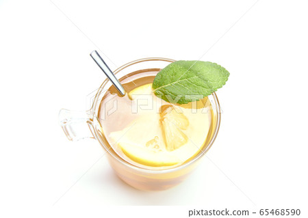 Hot cup of tea with lemon and mint leaves on a 65468590