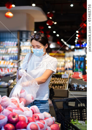 Asian woman shopping for fruit in the market Asian woman shopping for fruit in the market 65468756