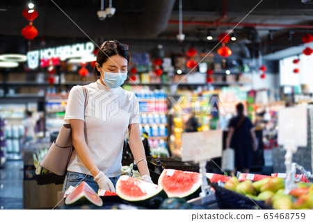 Asian woman shopping for groceries in the market Asian woman shopping for groceries in the market 65468759