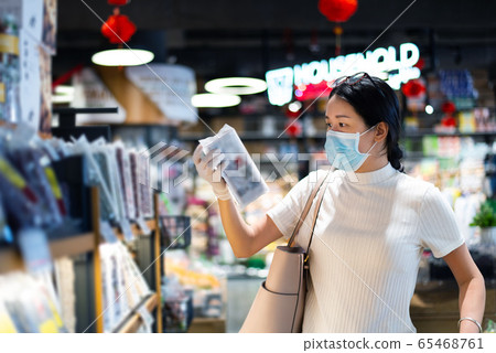Asian woman shopping for groceries in the market Asian woman shopping for groceries in the market 65468761