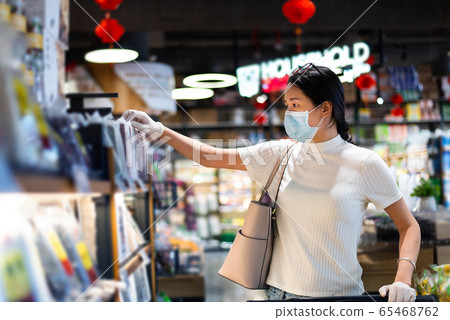 Asian woman shopping for groceries in the market 65468762