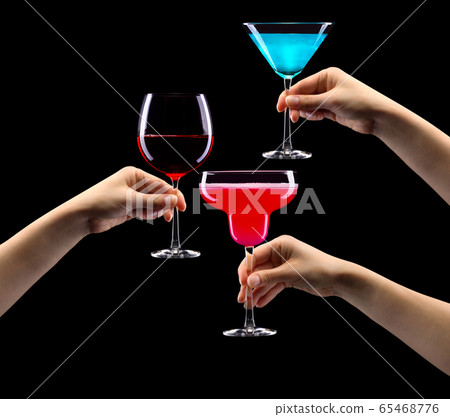 Set of hands holding cocktails isolated on black background Set of hands holding cocktails isolated on black background 65468776