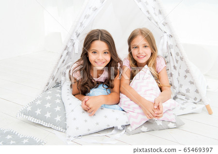 Sisters or best friends spend time together lay in 65469397