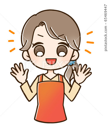 Woman in an apron smiles with both hands raised 65469447