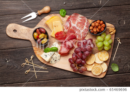 Cheese, meat, grapes and olives antipasto 65469696